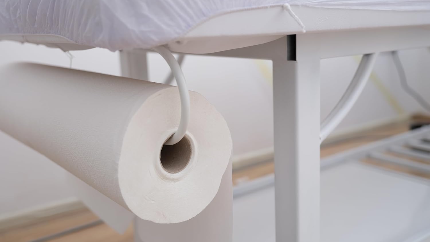 Roll of white paper on a table with a white surface in the background