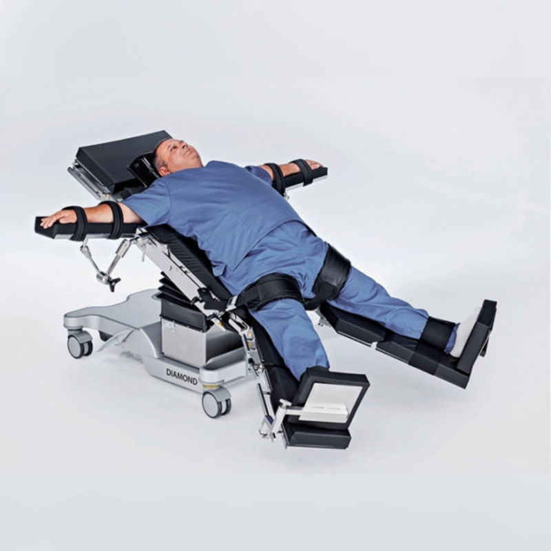 Person lying on a medical examination table with straps on a white background