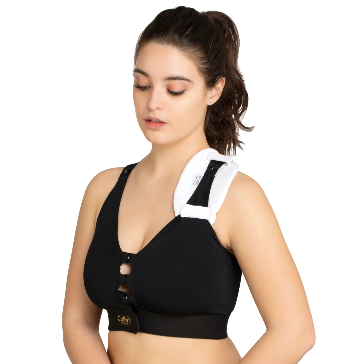 Woman wearing a black sports bra with white shoulder pads on a white background