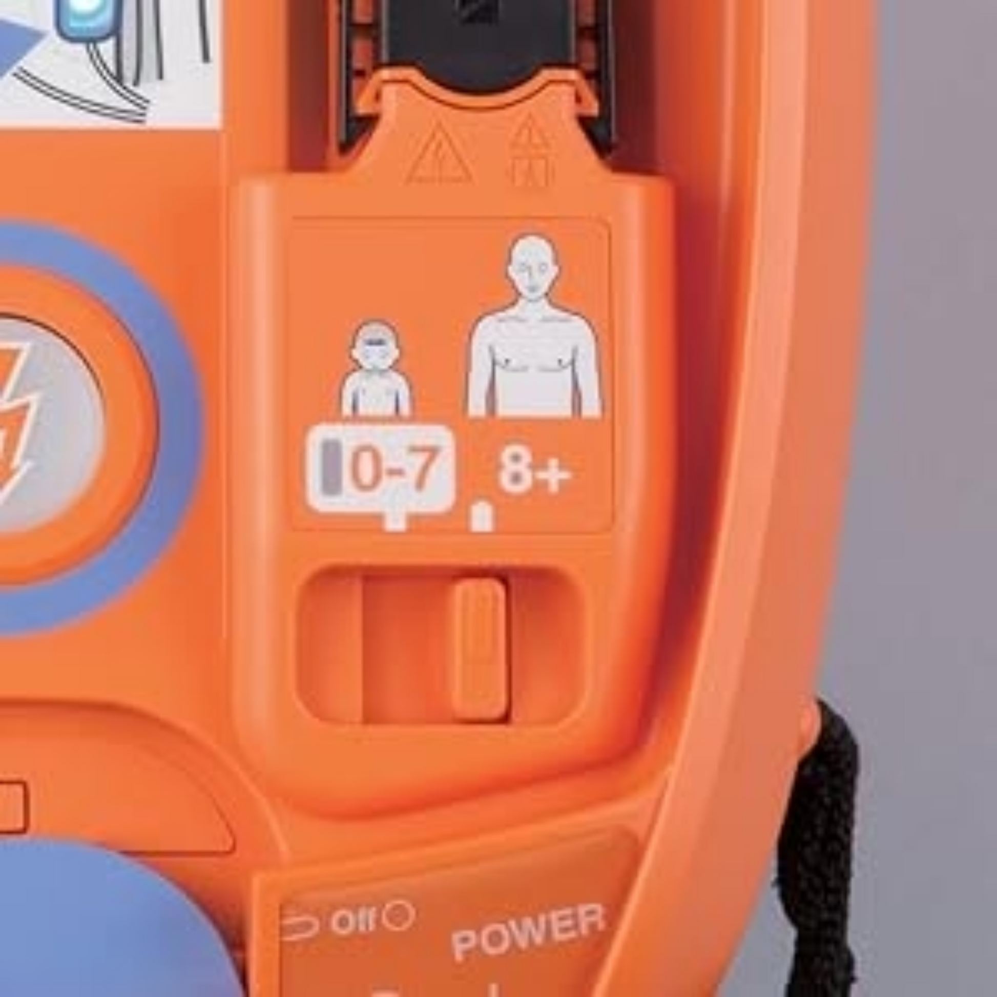 Close-up of an orange electronic device with icons and text on a gray background