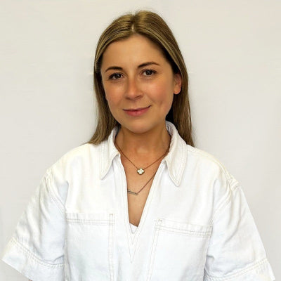Woman wearing a white shirt against a plain background